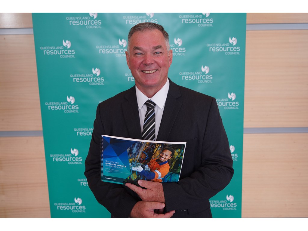 Resources Minister Scott Stewart with a copy of the draft Queensland Resources Industry Development Plan