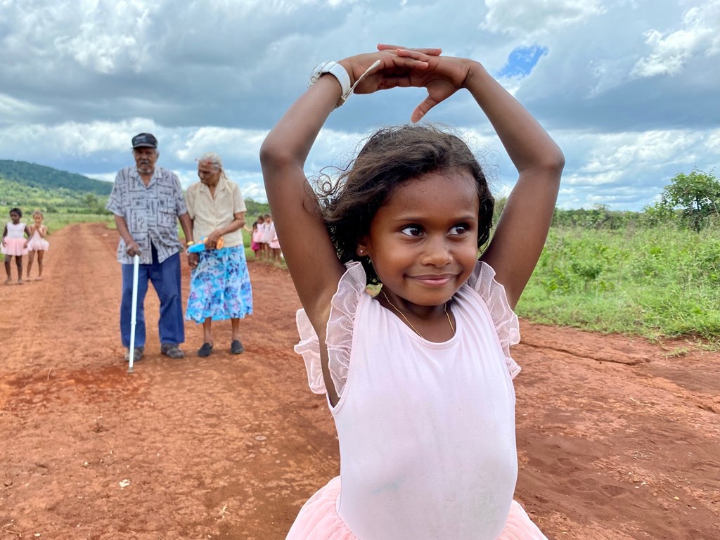 Hazel Port, 6, and the barefoot ballerinas with stolen generation survivors Ella Woibo, 88 and Frank Woibo, 93, at the former Aboriginal mission of Hope Vale. 