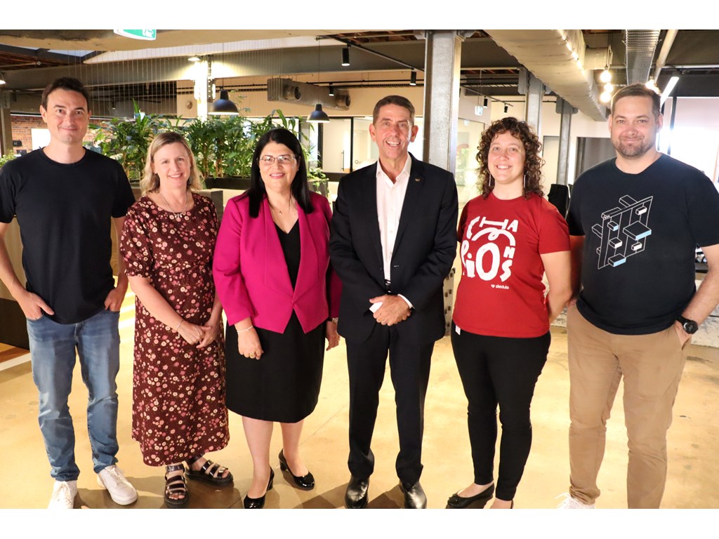 Treasurer Cameron Dick and Education Minister Grace Grace with members of the Skedulo team at their Fortitude Valley office.