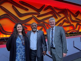 Sport Minister Stirling Hinchliffe with artist Dr Bianca Beetson and Adrian Coolwell in front of 'Welcome' at Suncorp Stadium.