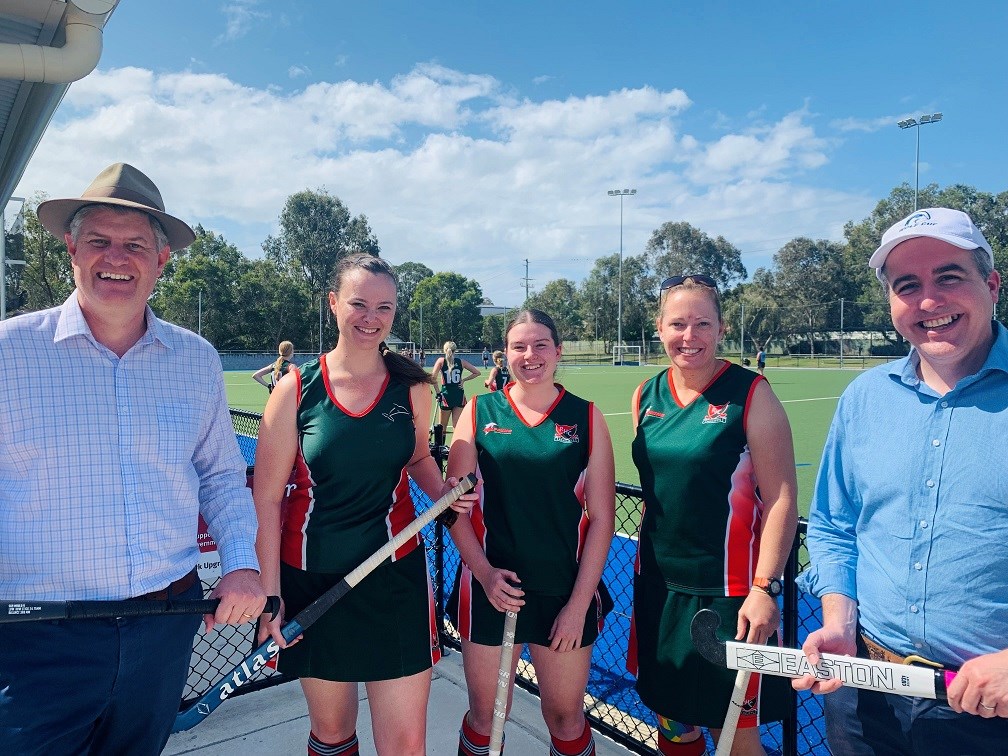 Sport Minister Stirling Hinchliffe, Member for Stafford Jimmy Sullivan and Redcliffe Dolphin players at Burringbar Park Hockey