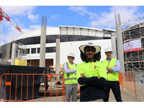 Cairns Convention Centre's 50th apprentice Tim Hehona with Lendlease construction manager Kip Hayes and Minister Mick de Brenni onsite