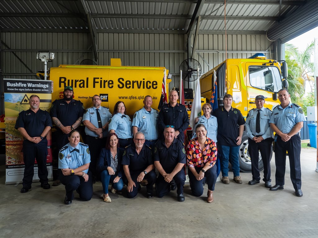 Minister for Fire Nikki Boyd, Member for Keppel Brittany Lauga, and RFS Chief Officer Ben Millington with members of The Caves Rural Fire Service.