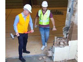 Sport Minister Stirling Hinchliffe and discus athlete Matt Denny get started on demolition work at QSAC's indoor court.  